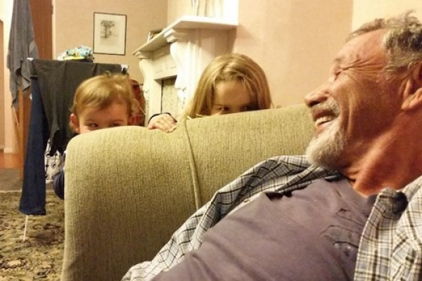 Grandfather smiling at grandchildren