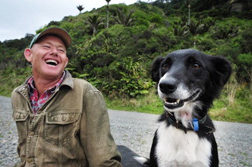 Happy farmer and his dog outside
