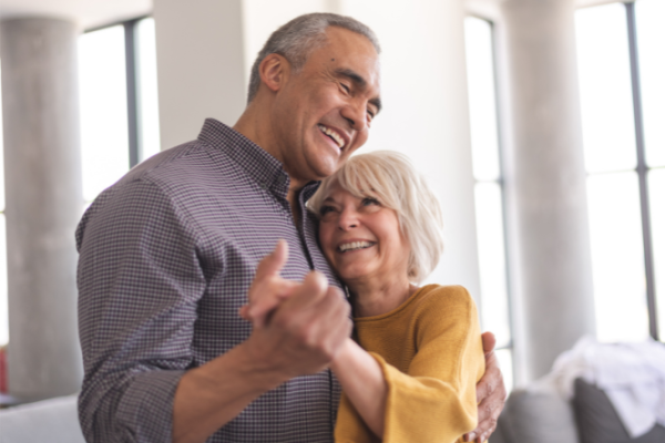 Older couple dancing and smiling