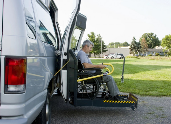 MAn in wheelchair using mobility van