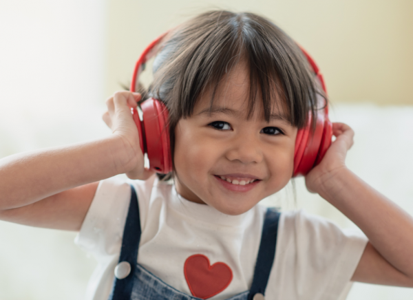 Small girl wearing headphones for ear protection