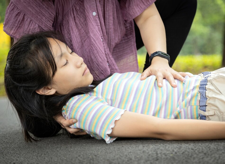 Young girl who fainted on road being helped