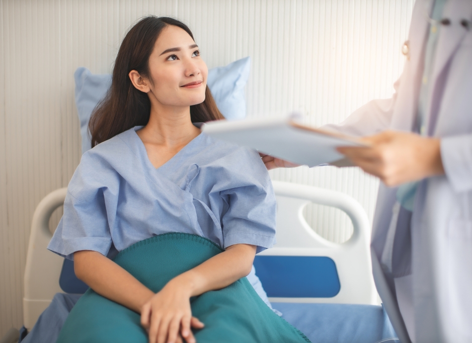 Asian woman in hospital bed