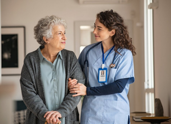 Nurse helps older lady while walking