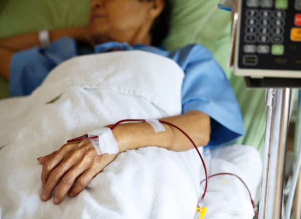 Woman in hospital bed having a blood transfusion 