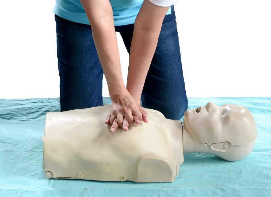 Woman learning how to do CPR with dummy
