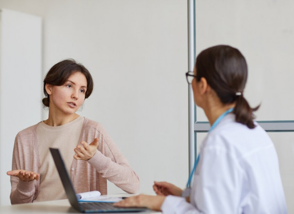 Woman talking to doctor about complaint