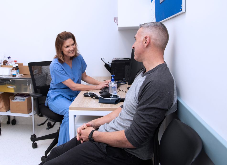 healthcare provider chats to male patient