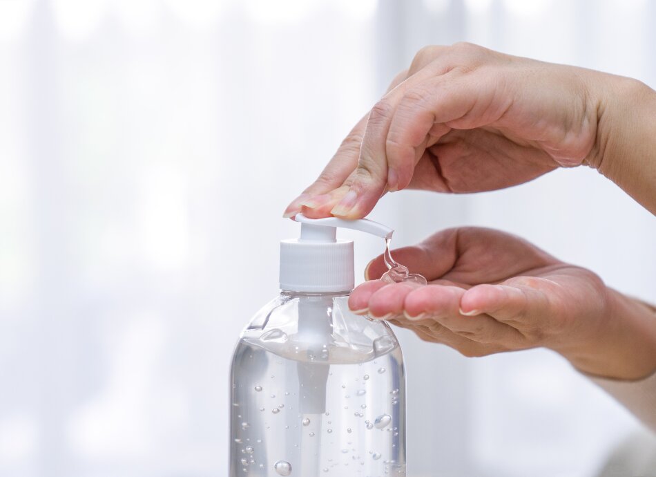 Woman's hands using clear hand sanitiser