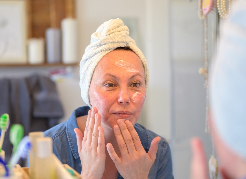 Applying moisturiser to face 