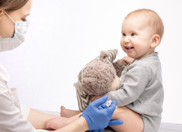 Baby receiving vaccination in thigh