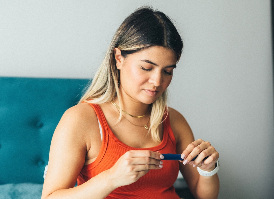 Woman with CGM on about to inject insulin