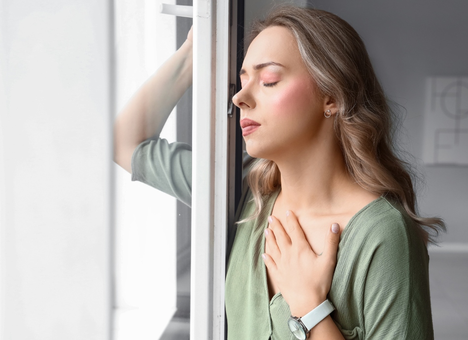 Young woman having panic attack, breathing through it