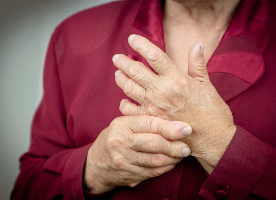 Older person's hand with rheumatoid arthritis