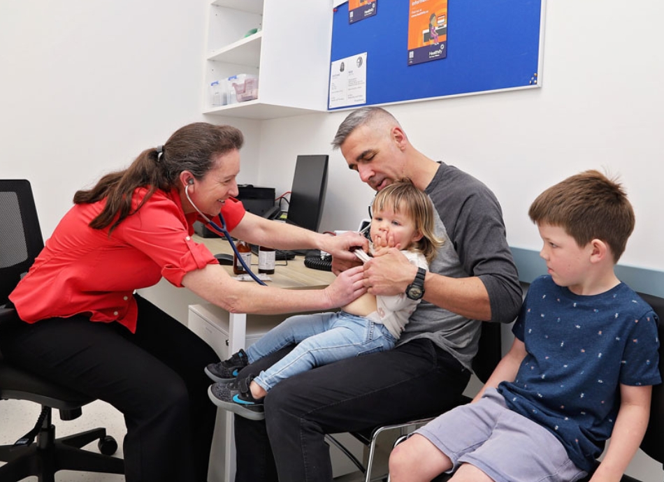 Doctor listening to child's chest