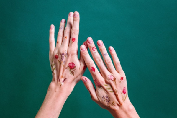 Hands with temporary flower tattoos