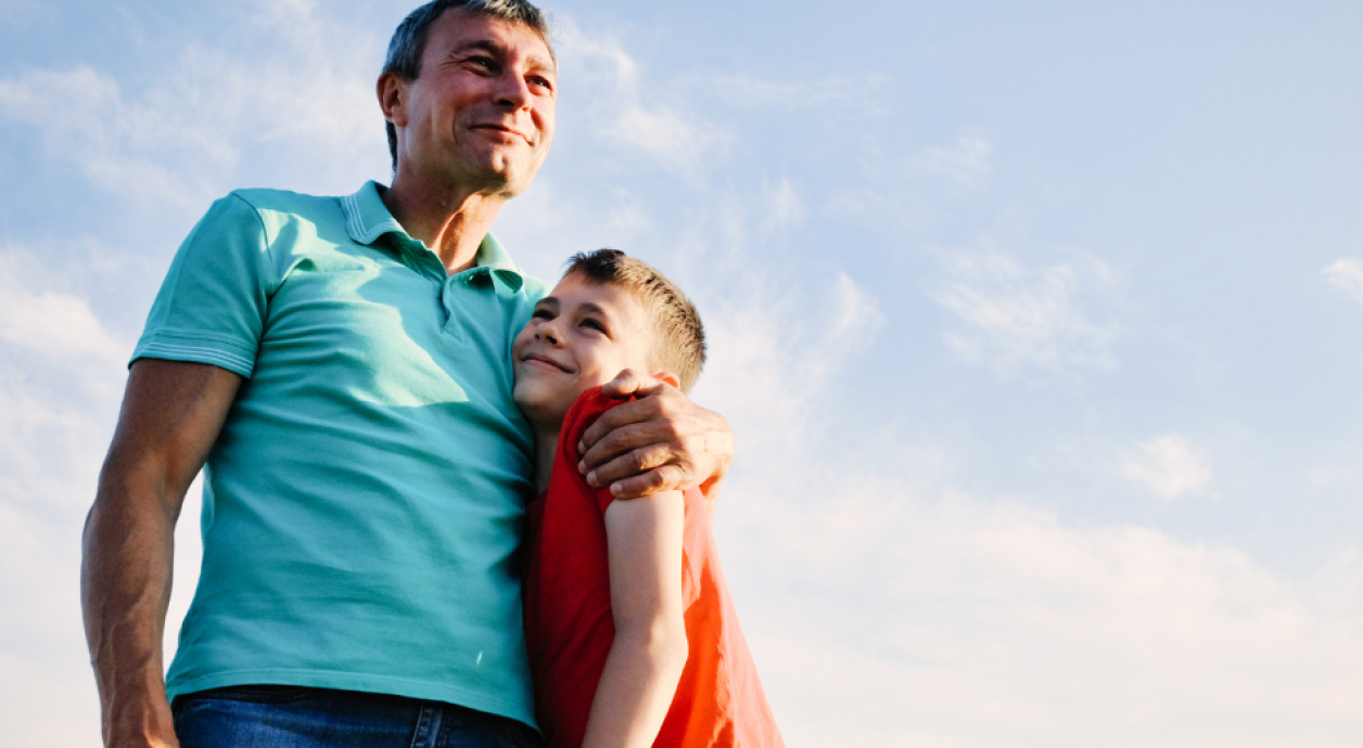Father and son hugging outside 