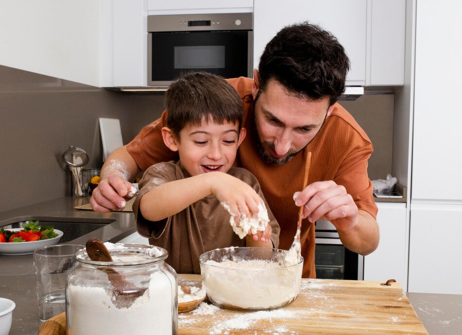 Father and son baking together in kitchen