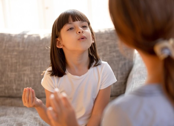 Girl with speech therapist copying sounds