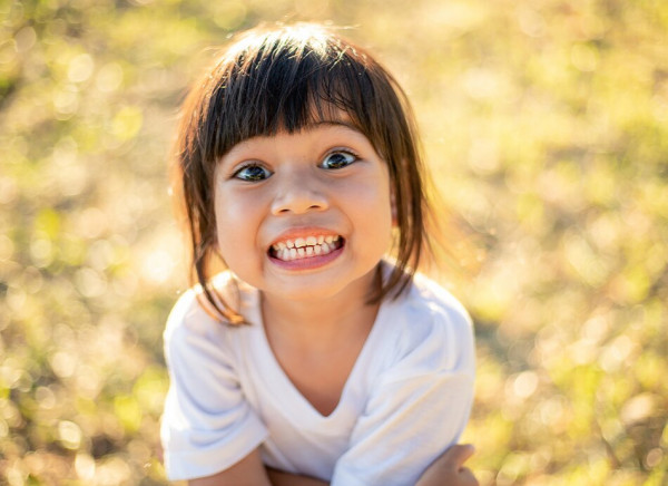 Preschool child showing healthy teeth