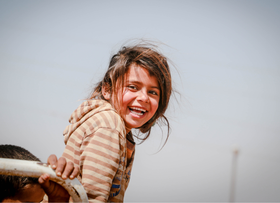 Smiling young refugee girl