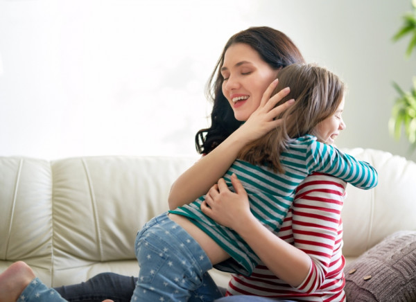 Woman hugging her daughter