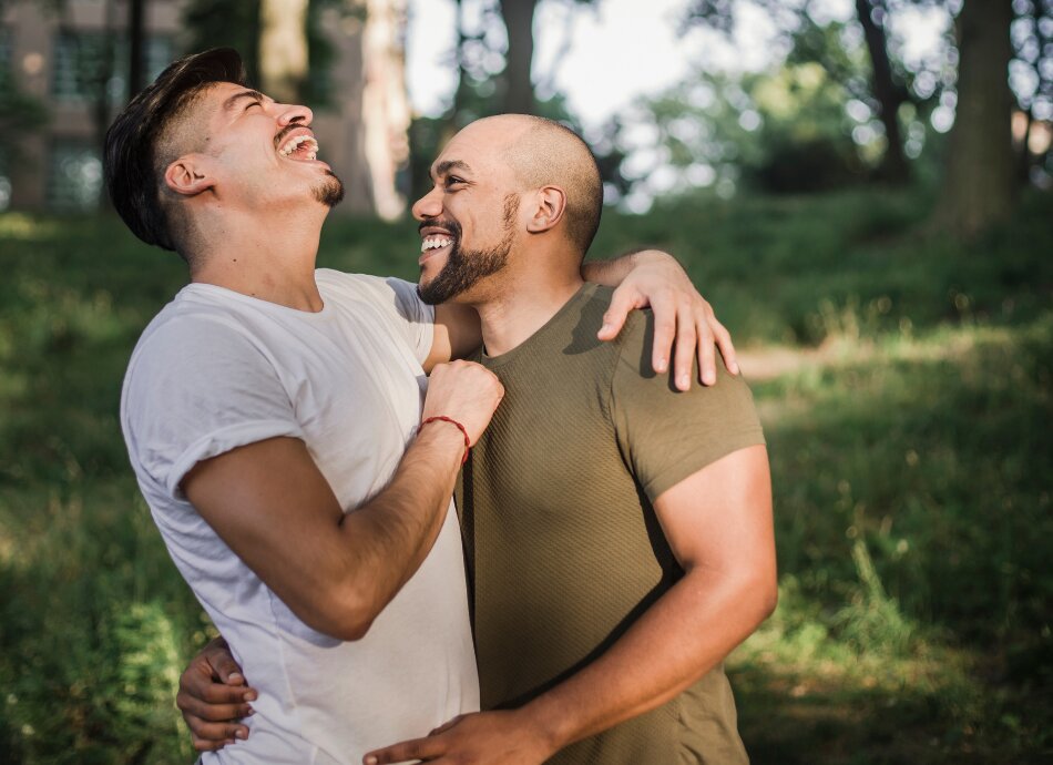 Two young men laughing outdoors