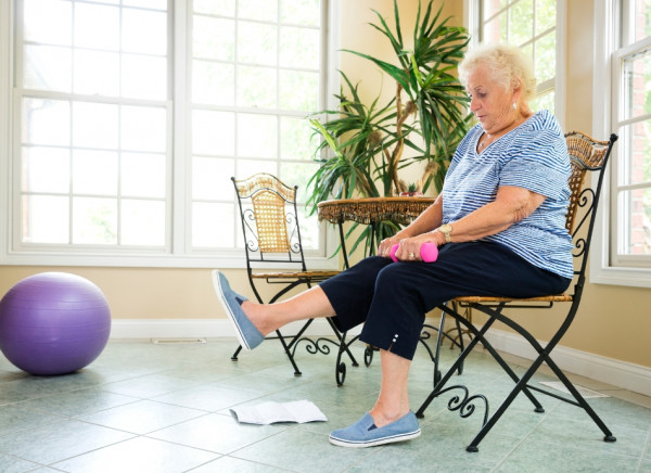 Older woman doing chair based exercises