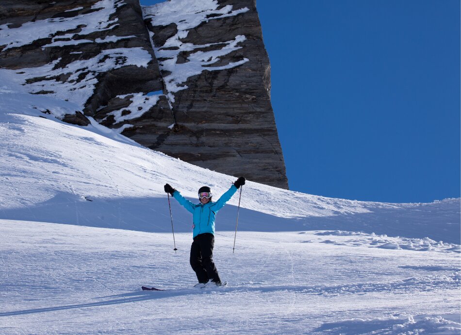 Skier waving from slopes in New Zealand