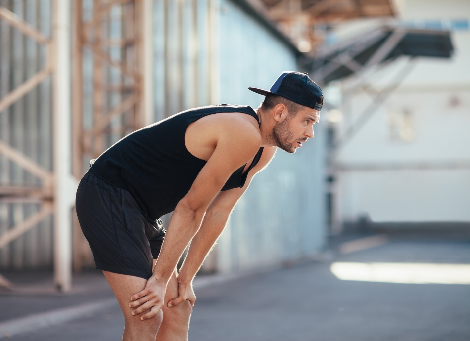 Tired man taking a break while exercising