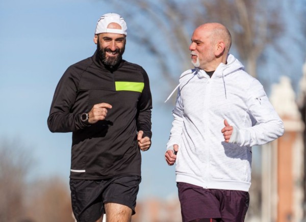 Two men talking while they exercise