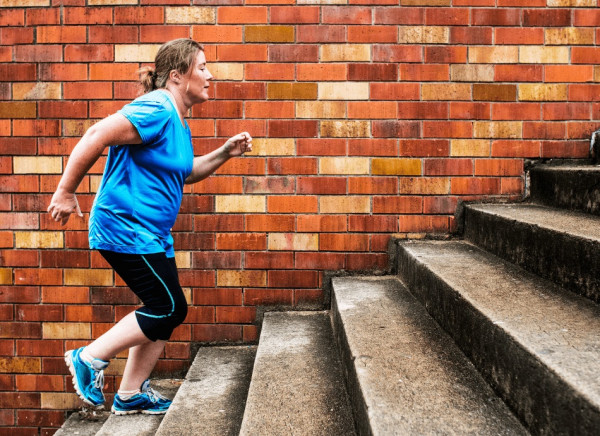 Woman running up steps for exercise