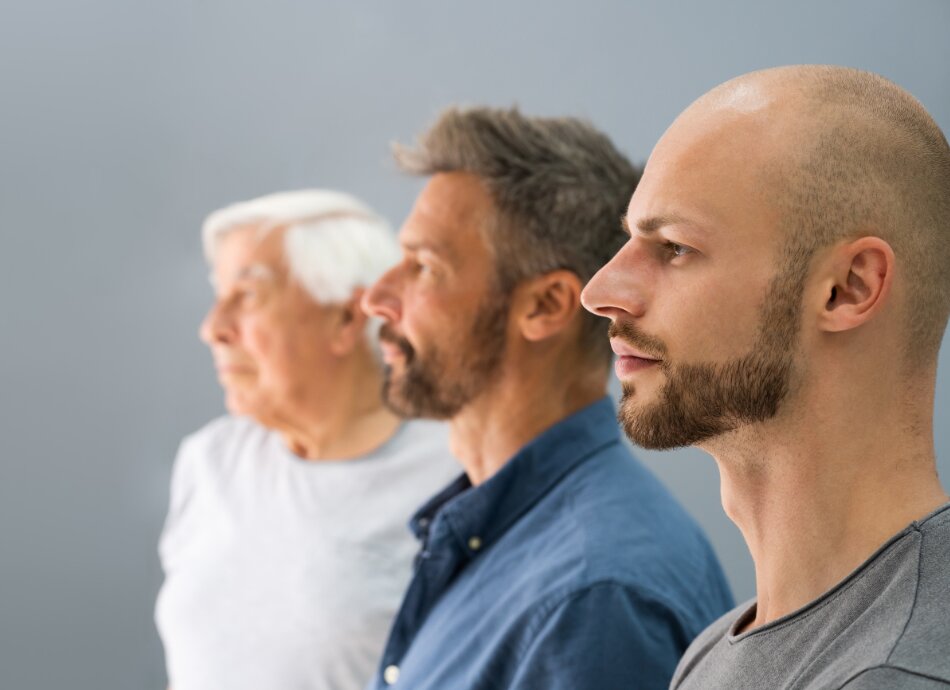 Three generations of men lined up