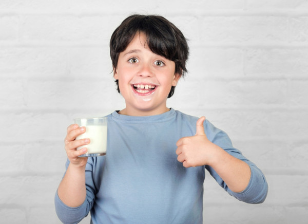 Boy drinking milk and giving the thumbs up