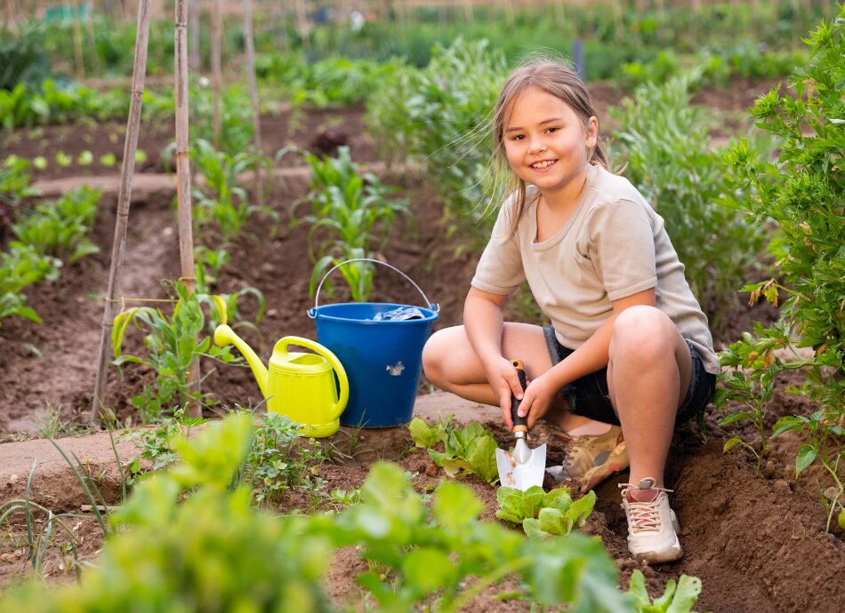Girl working in vegetable garden