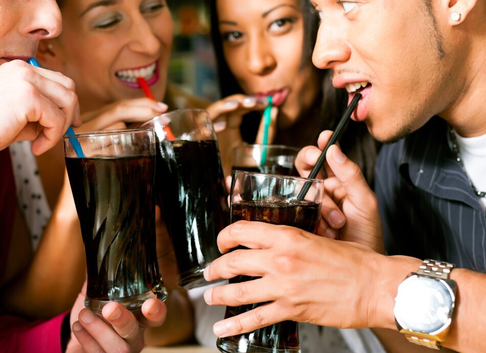 4 friends drinking sugary soft-drinks
