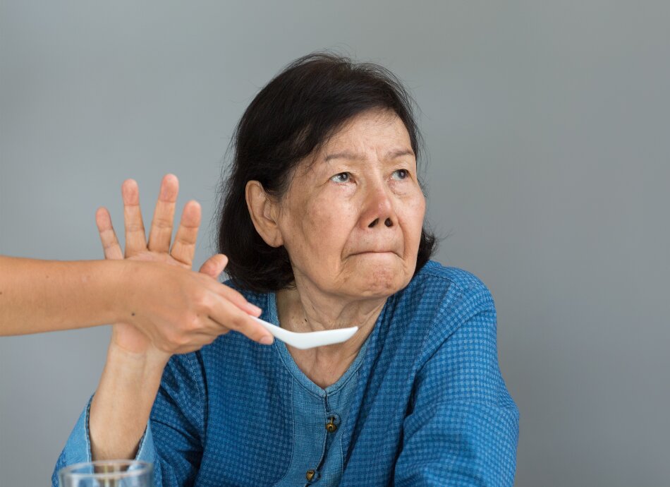Older woman refusing food being offered