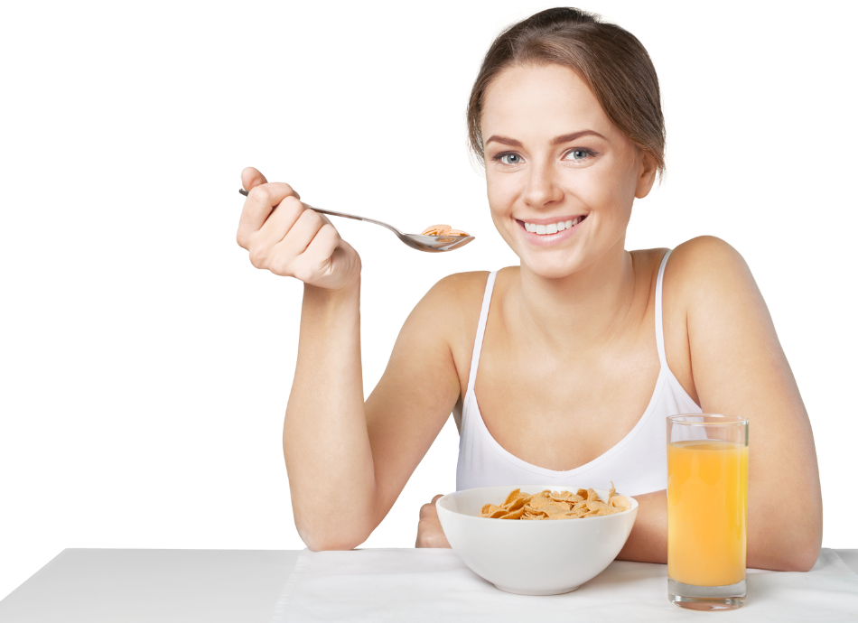Young woman having cereal and orange juice 