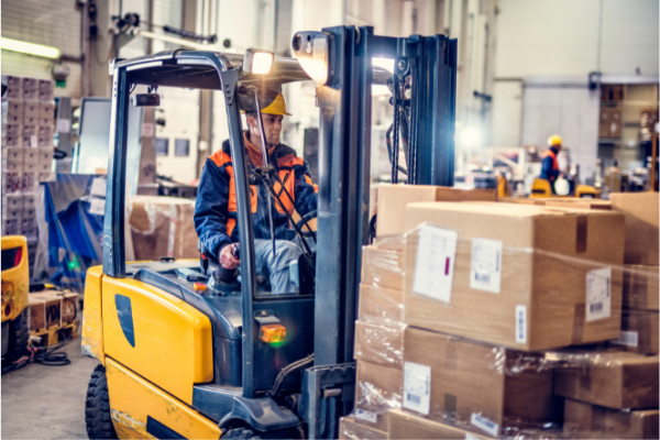 Man driving forklift in warehouse