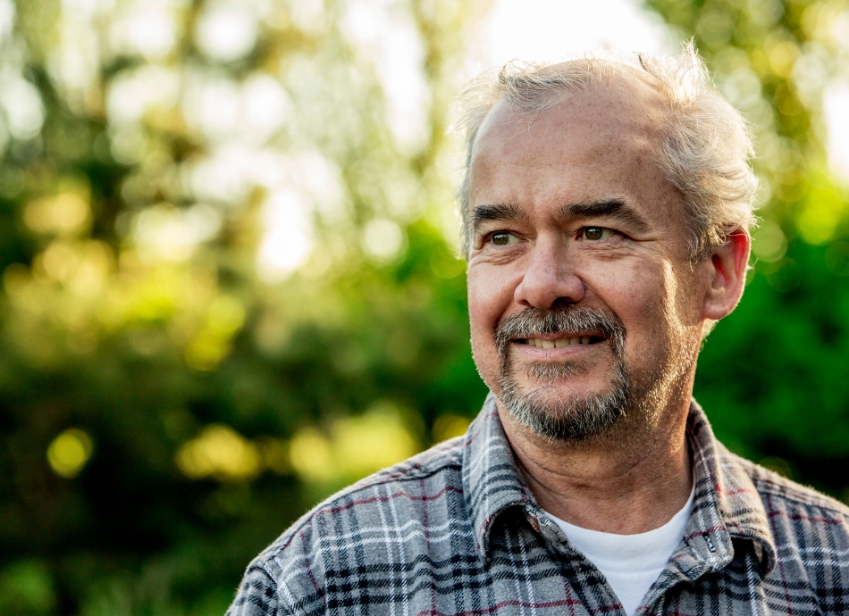 Head and shoulders of older man outside 