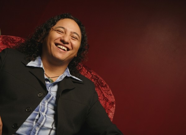 Laughing man sitting in red chair