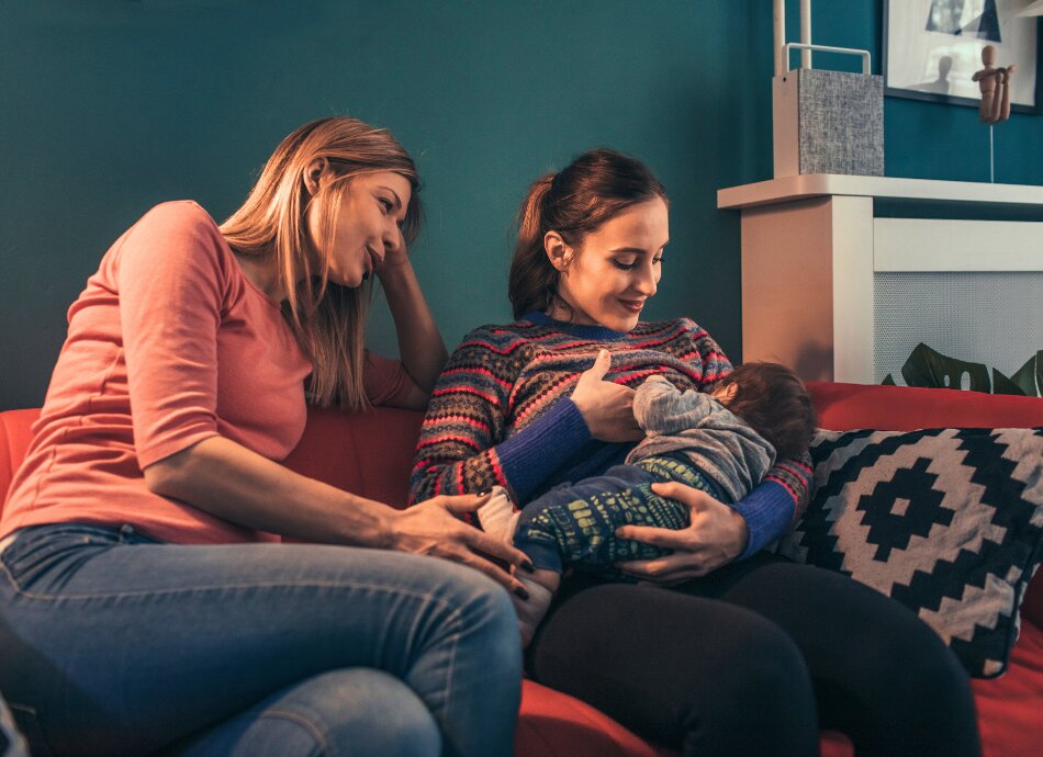 Lesbian couple with son breastfeeding 