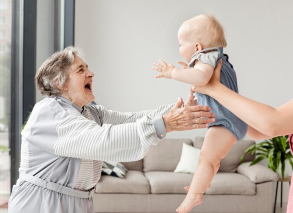 Older woman being visited by grandchild