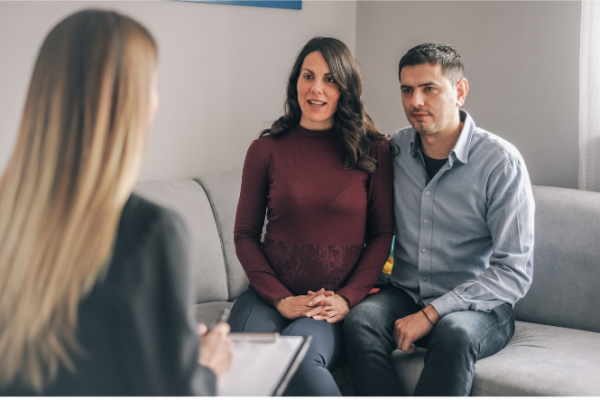 Pregnant couple talking to healthcare provider