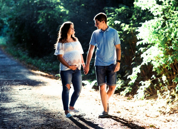 Pregnant couple walking  outside