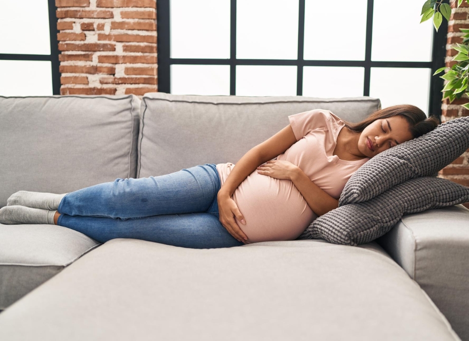 Pregnant woman resting on couch