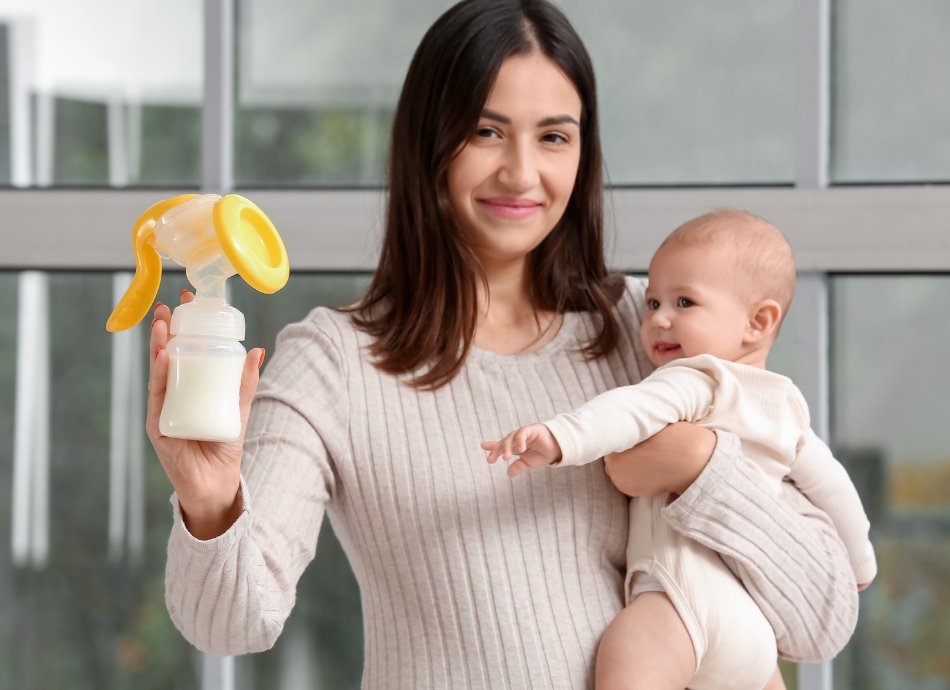 Young woman holding baby and expressed milk 