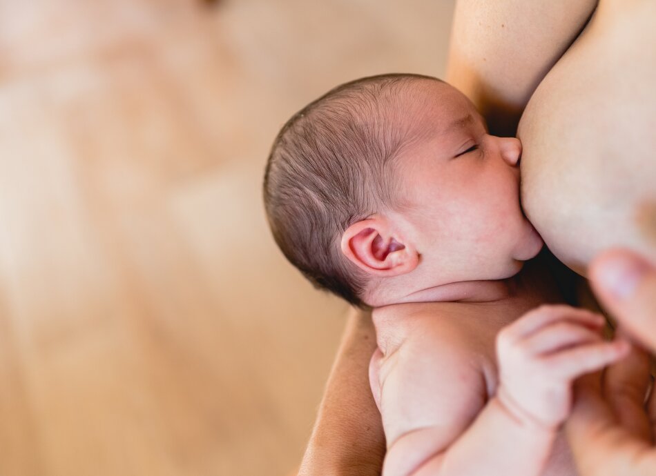 baby breastfeeding Canva