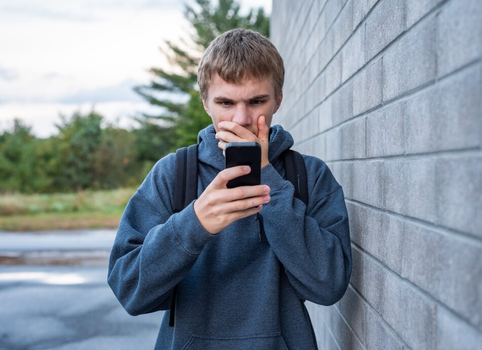 Teenager alarmed by something on cellphone