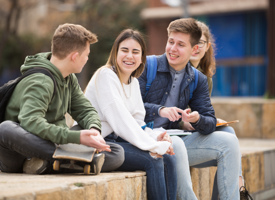 Teenagers laughing and chatting together